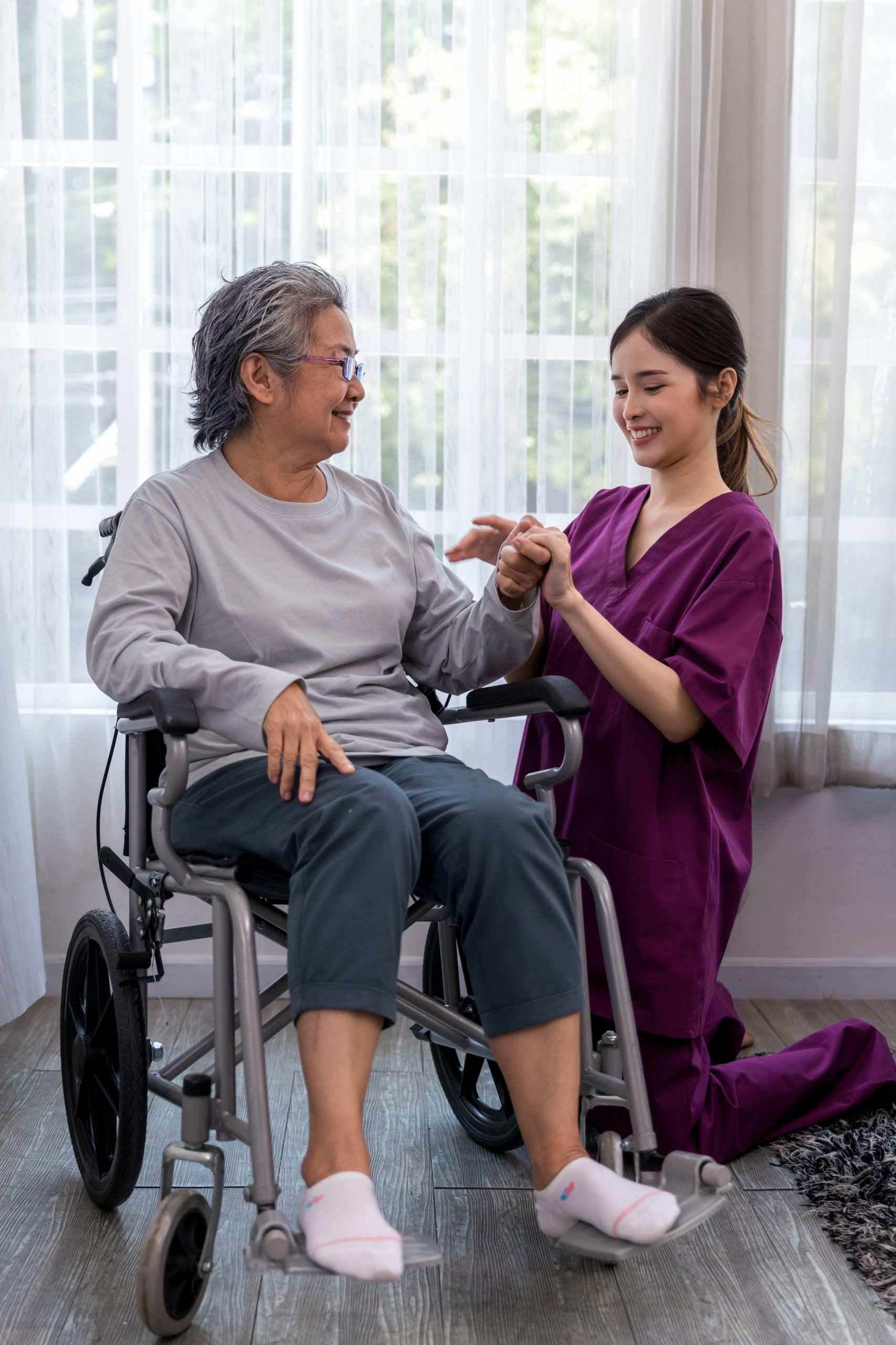Caregiver nurse take care a Senior patient sit on wheelchair. Nurse helping senior Woman